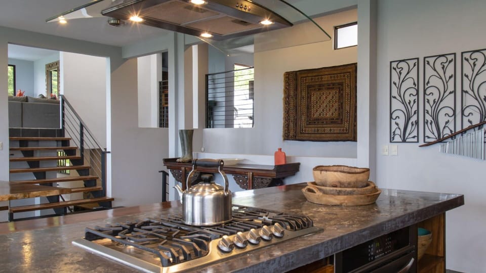 A huge stove and 2 ovens are featured in the kitchen