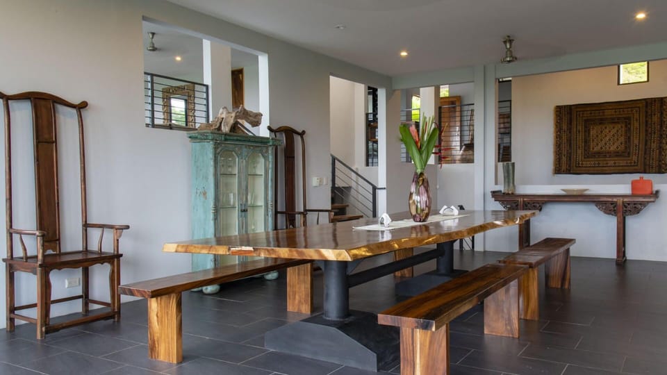 Unique furniture surrounds the huge harvest table in the dining room
