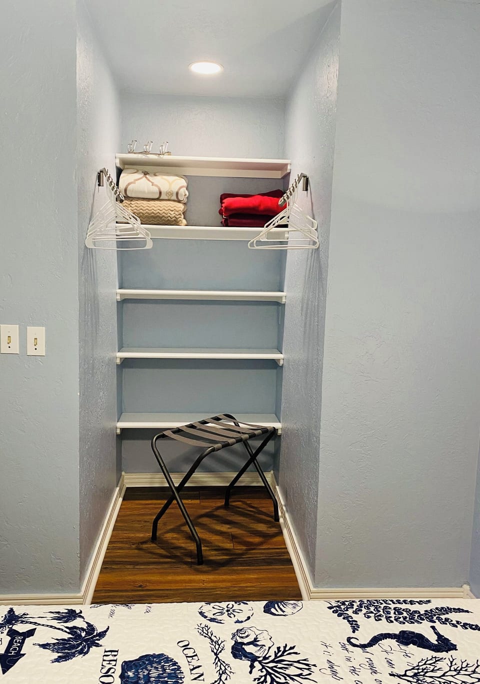 Closet with luggage rack, shelves, extra blankets, & hanging options 
