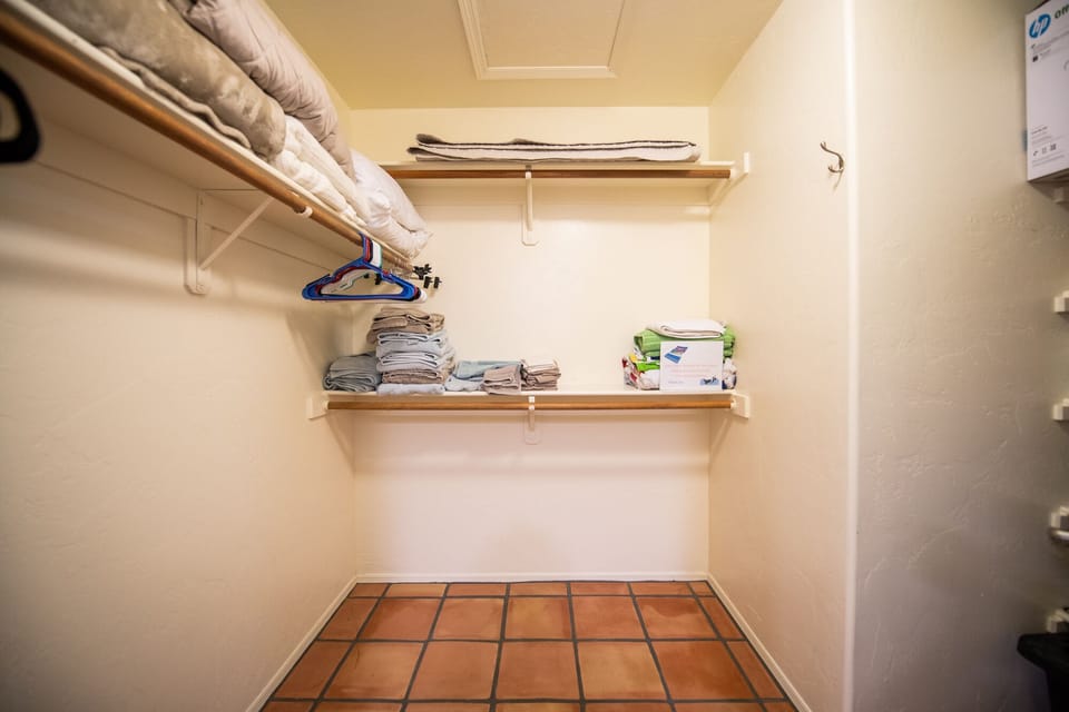 Huge walk-in closet with quality hangars, pool towels, extra pillows and linens.