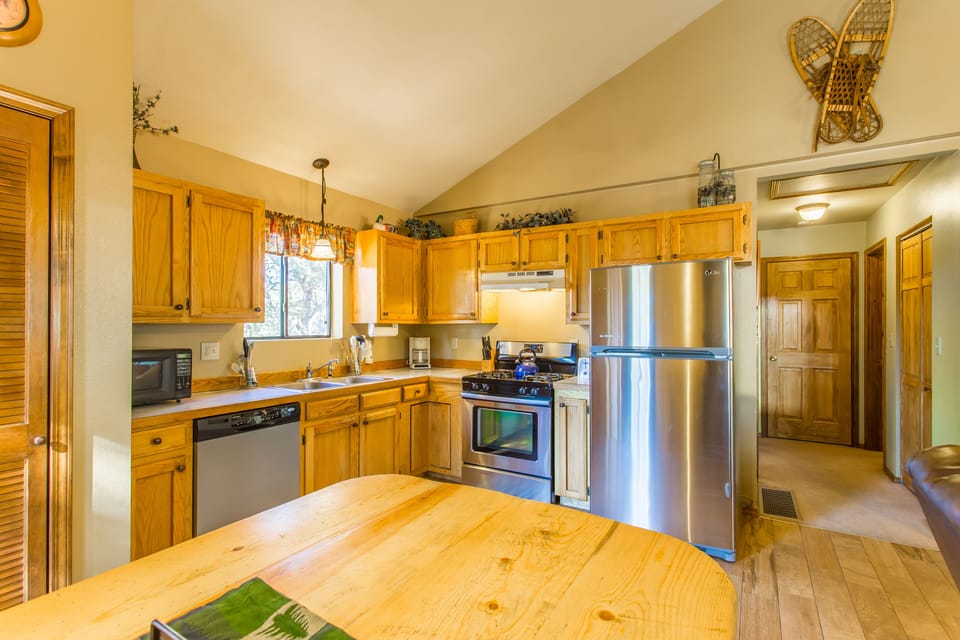 Well stocked, modern kitchen with stainless steel appliances. 