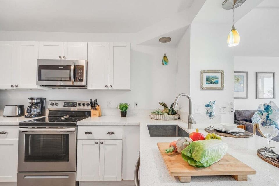Prepare breakfast in a bright white kitchen with sleek stainless appliances