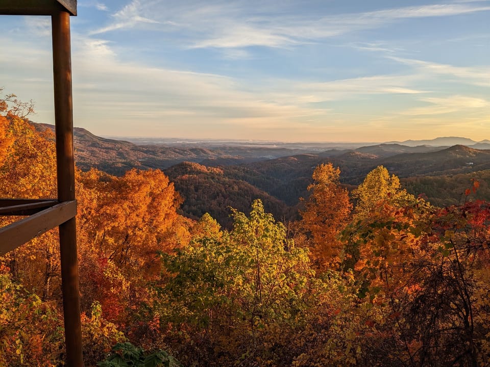 - Fall foliage panorama bursting with orange and gold mountain colors   - Breathtaking seasonal scenery right outside your cabin door   - Capture autumn magic in the heart of the Smoky Mountains