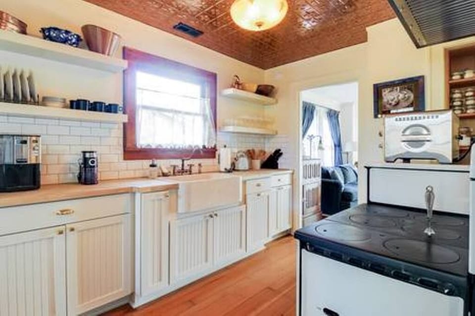 The fully renovated kitchen with marble sink and butcher block counters