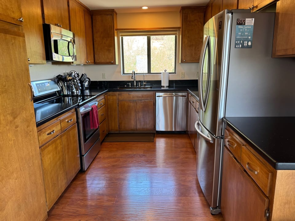 Galley kitchen full of appliances, utensils, Keurig, Mr Coffee, spices, toaster