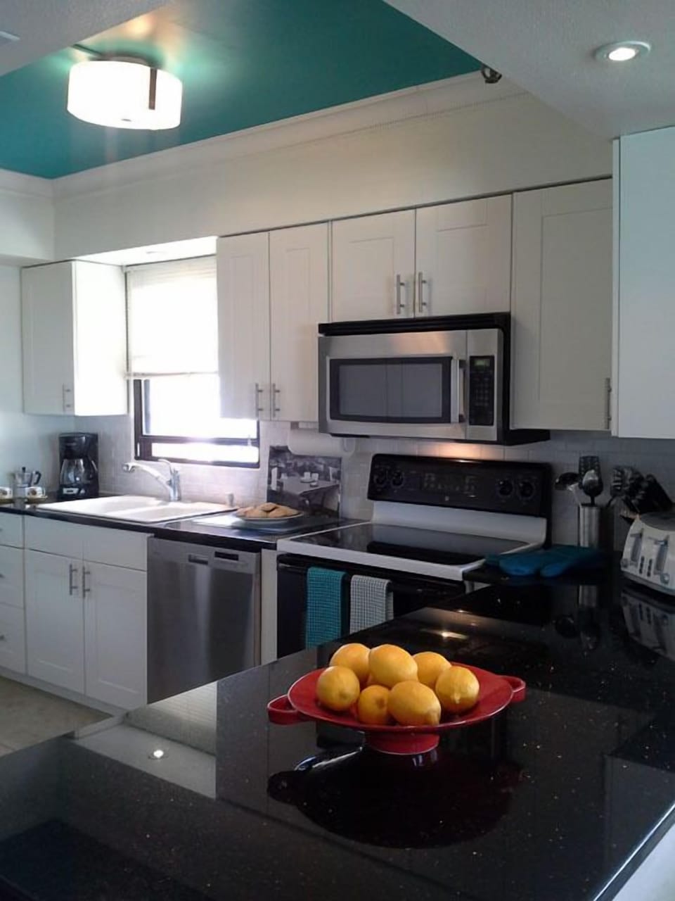 Kitchen window ~ stainless steel appliances ~ granite countertop.