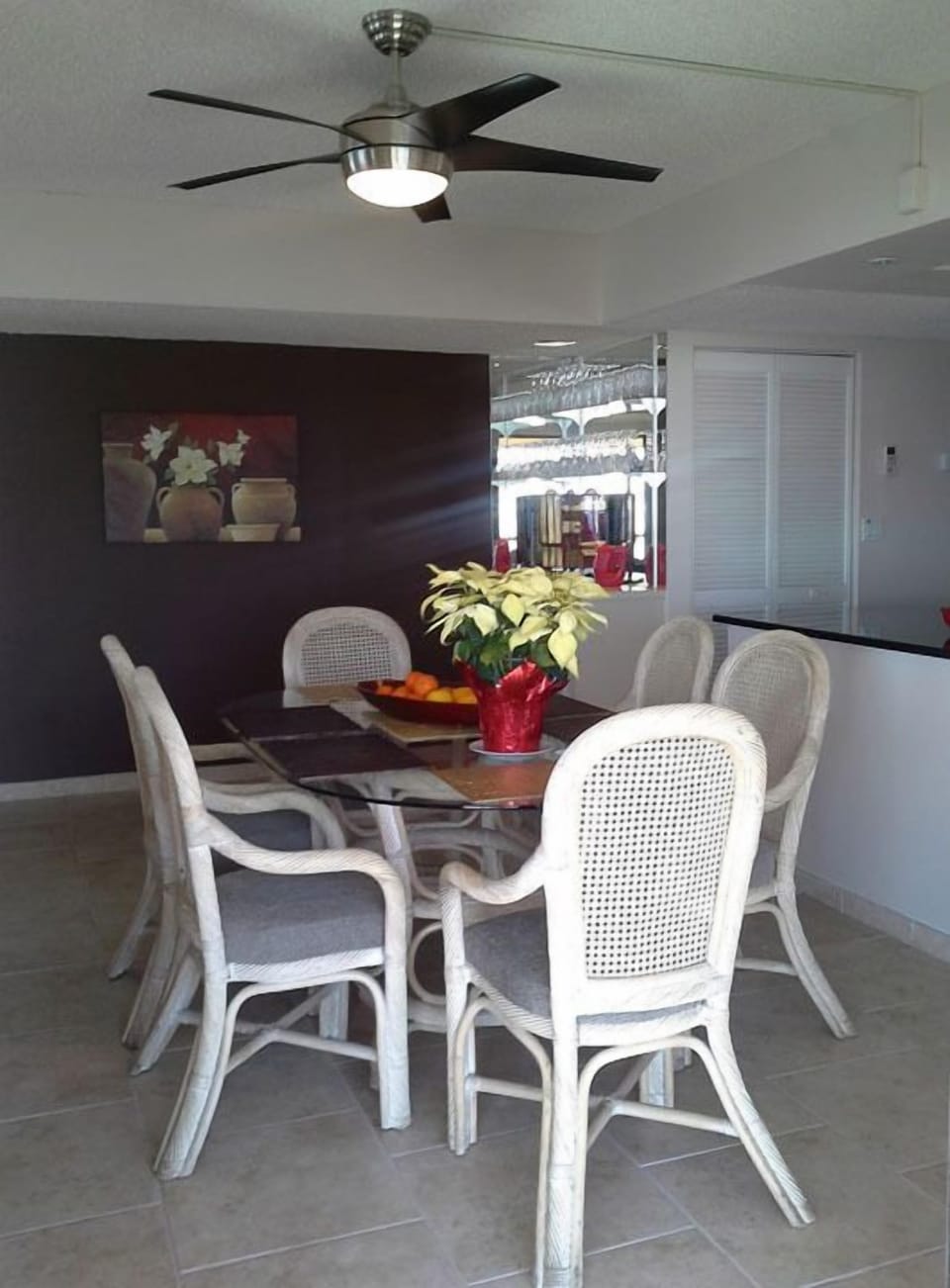 Dining area with updated remote ceiling fan.