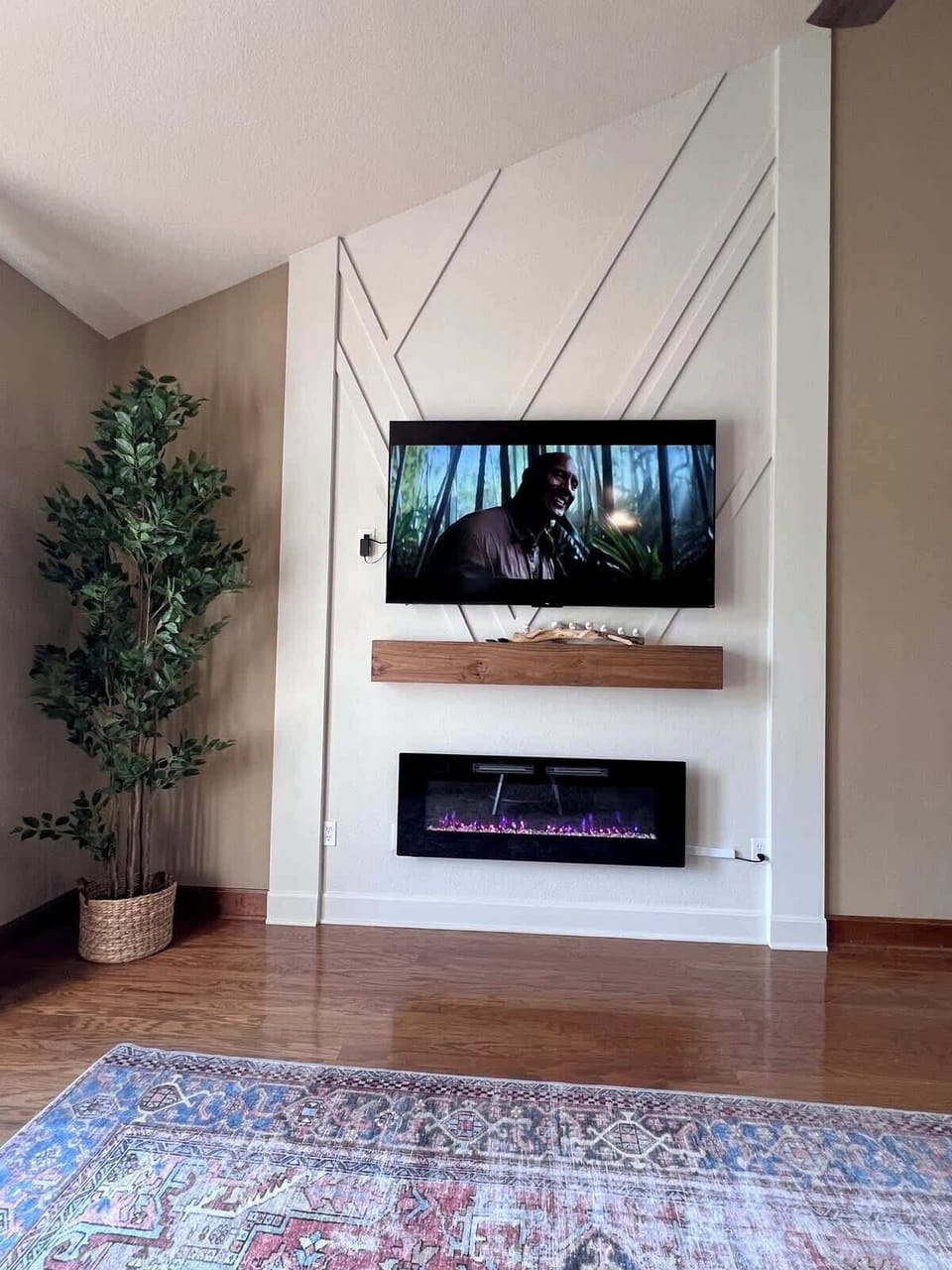 main living room with 65" smart tv and electric fireplace