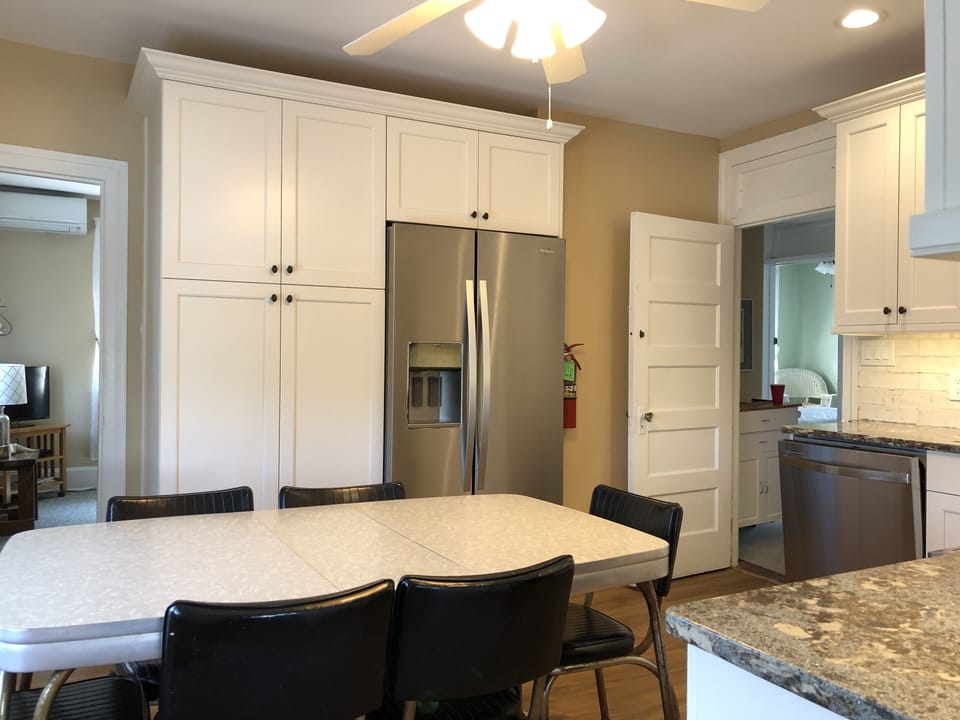 Kitchen with full size, stainless steel fridge/freezer with ice/water dispenser.