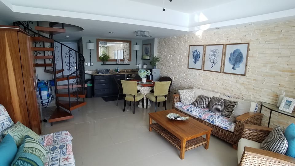 Kitchen and dining area viewed from living room. Note stacked stone wall.