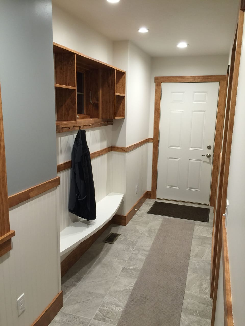 Hallway, bench and coat hooks.  Door leads to garage
