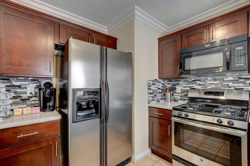 K-cup coffee maker and coffee pods, sugar, cream, tea and tea kettle are provided. 