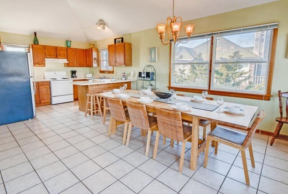 A grand dining room table, offering ample space for hosting family and friends in style.