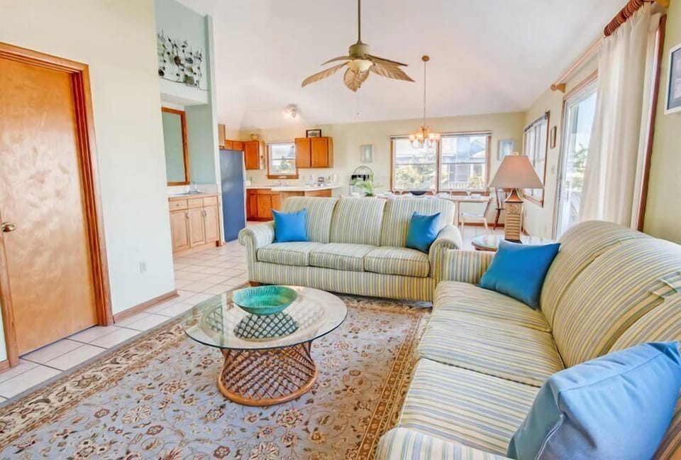 A generously sized great room featuring ample seating, perfect for relaxation and entertaining guests.