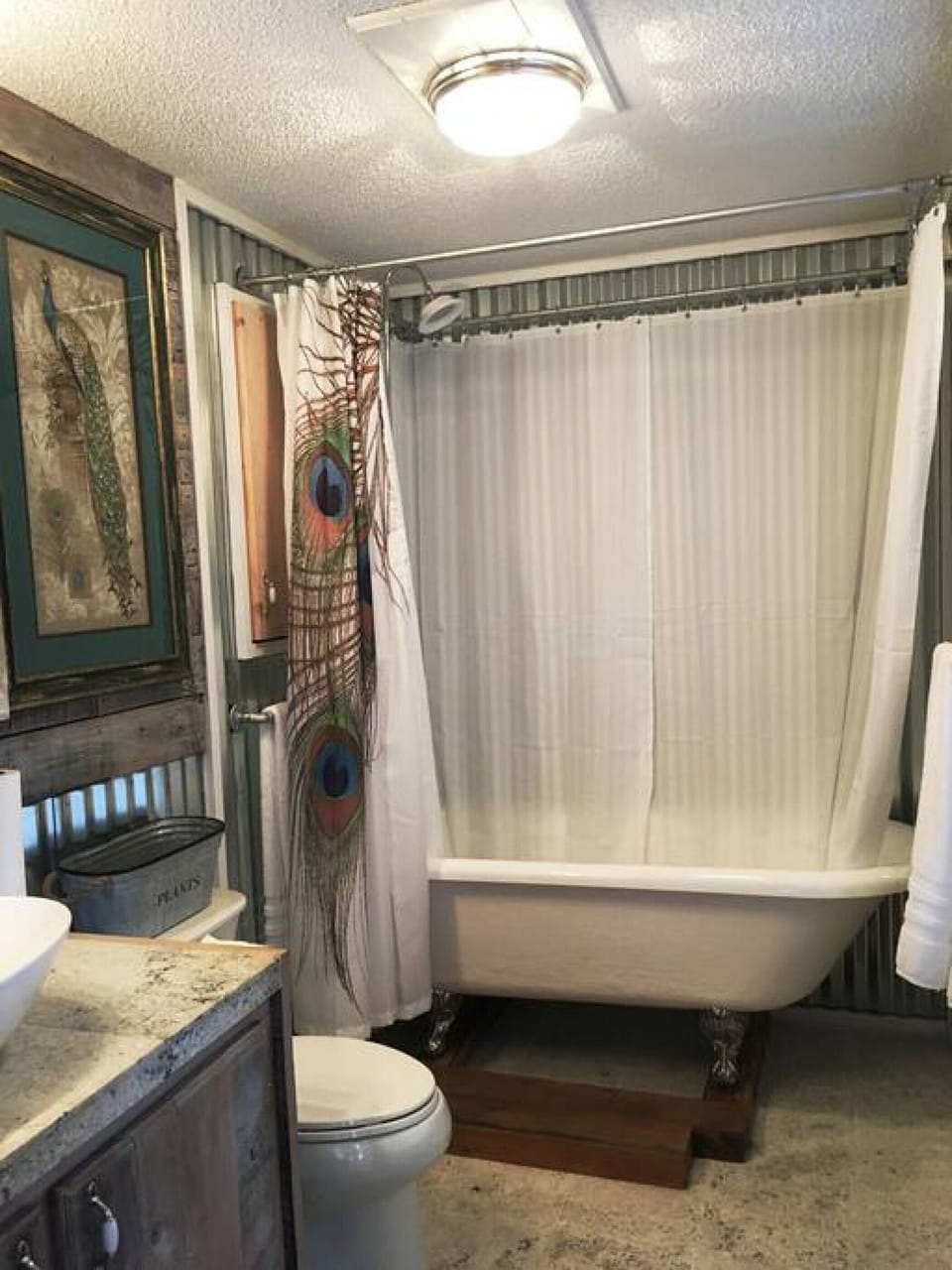 Private master bath with a soaking, claw-foot tub.