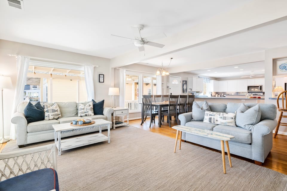 The living room offers 2 comfortable couches, 2 additional chairs, smart tv and sliding glass doors to access the beach side porch.