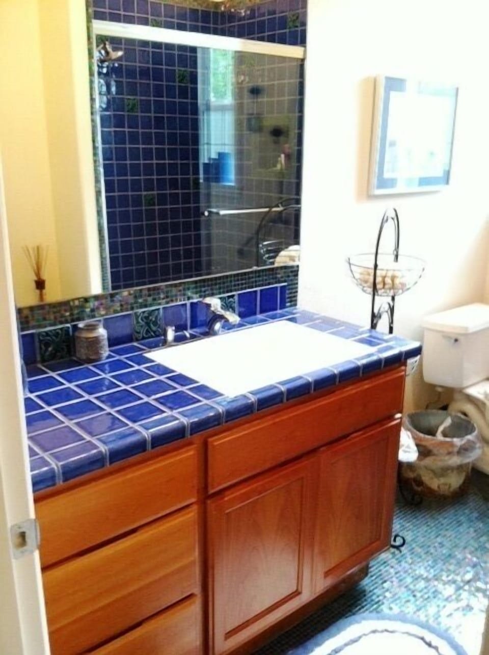 Custom tiled bathroom with cherry wood cabinets and instant hot water.