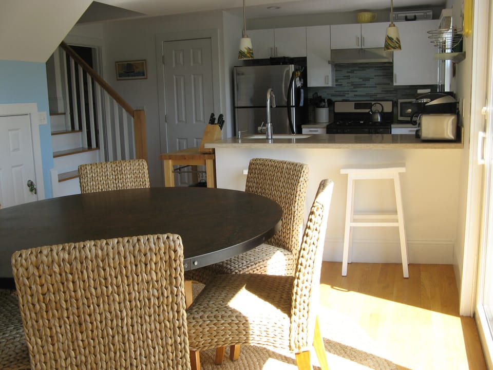 Dining area, breakfast bar and kitchen. Sliding doors to the right lead to deck.