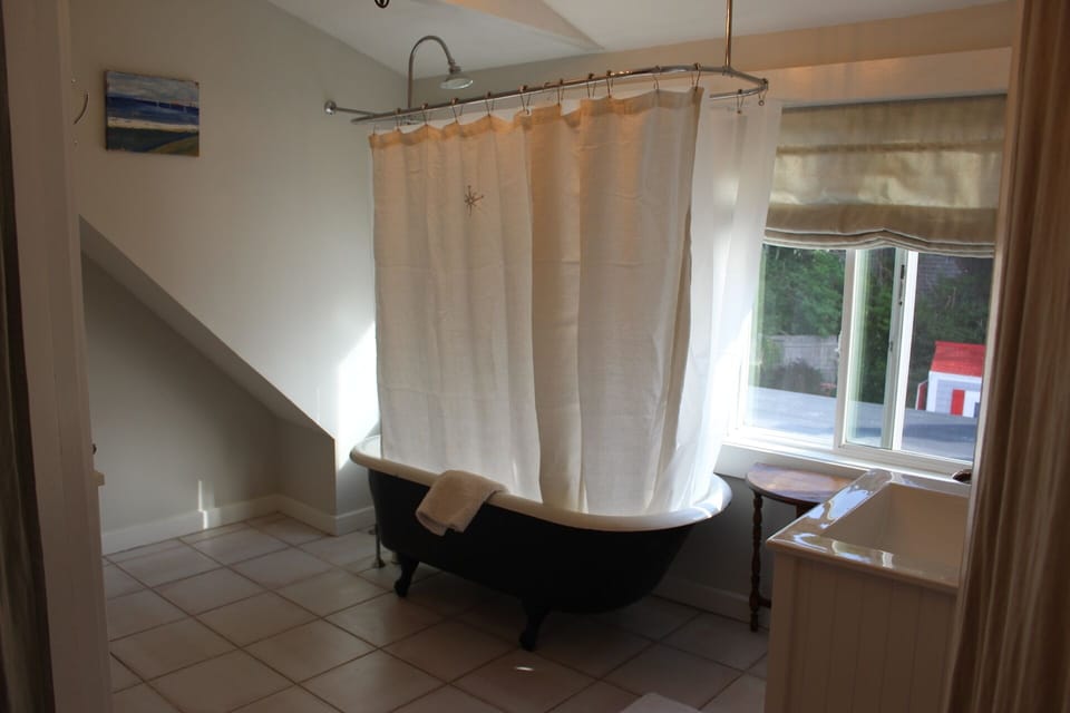 Bathroom with claw bathtub.