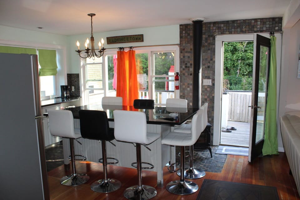 kitchen island with door to the deck and the backyard 