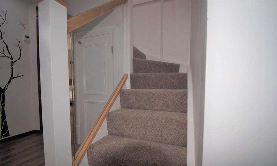 Staircase up to gallery and first floor bedroom