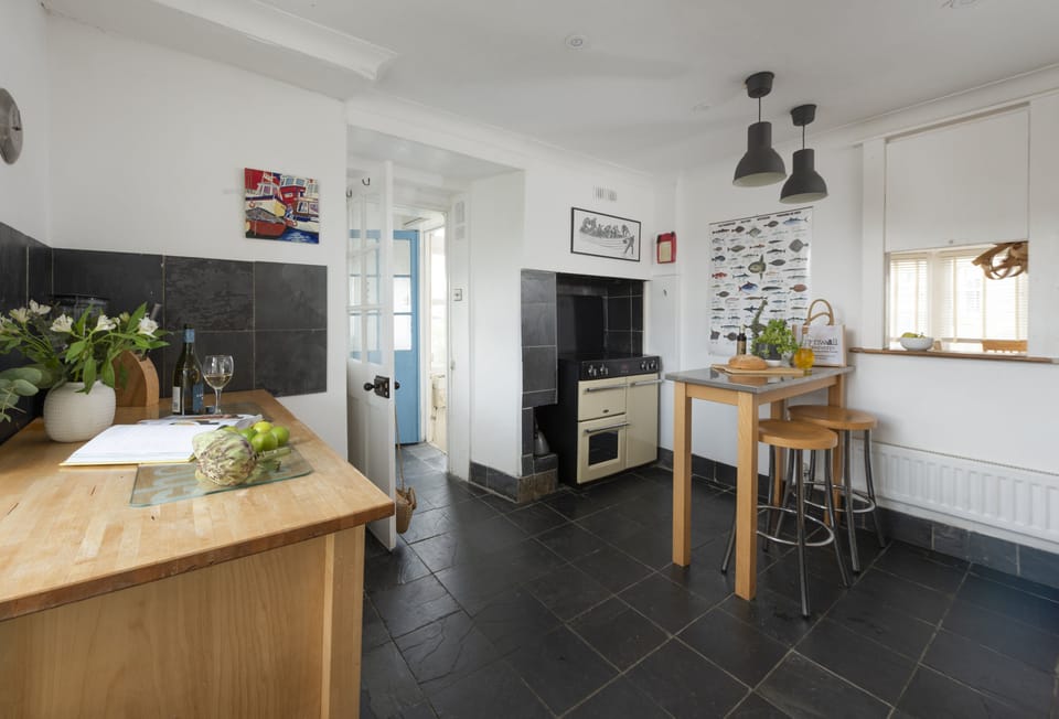 Trethoway, Port Isaac: Kitchen with a range cooker, small breakfast bar, dishwasher, large fridge and separate freezer.