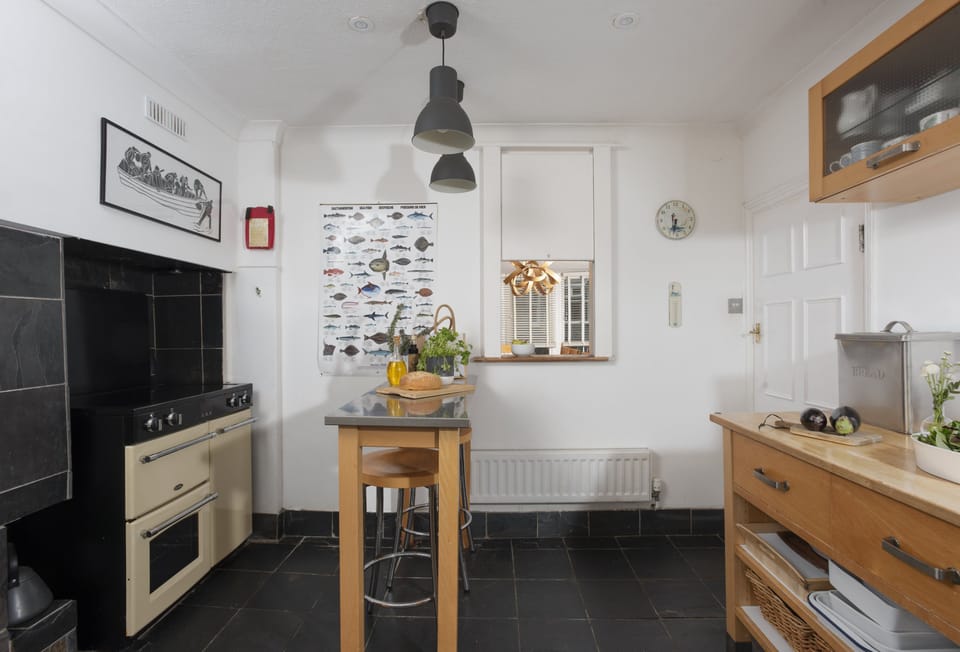 Trethoway, Port Isaac: Kitchen with a range cooker, small breakfast bar, dishwasher, large fridge and separate freezer.