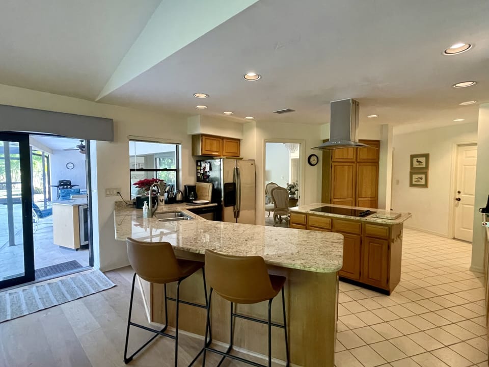 Kitchen breakfast bar leading to pool area