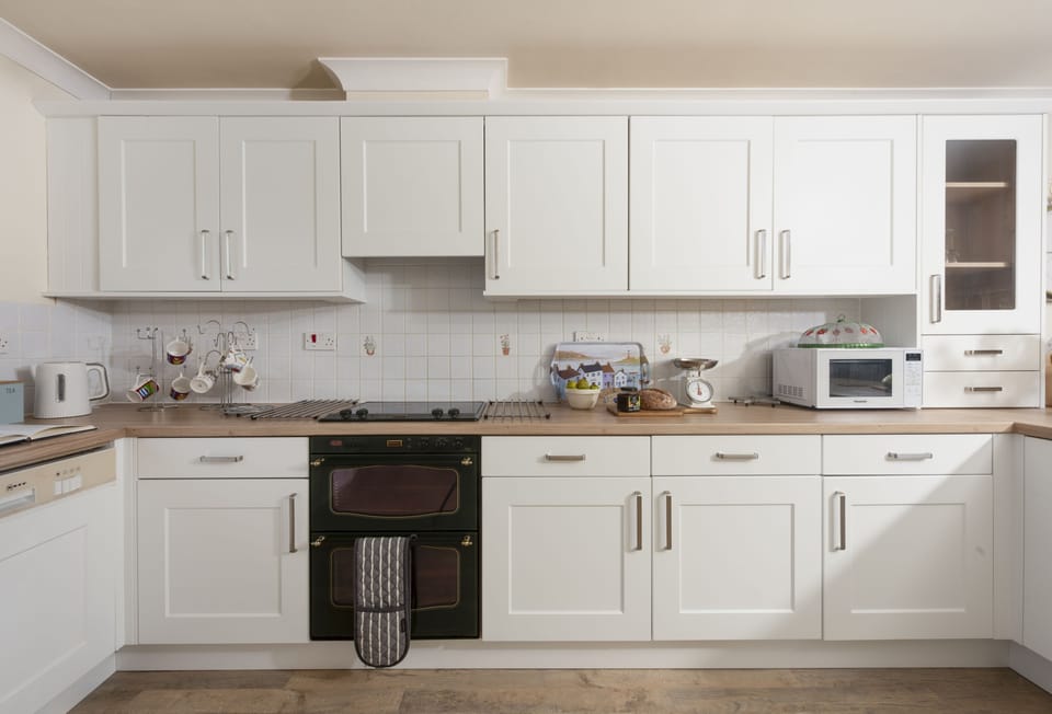 Keepers Cottage, Polzeath. First floor: Kitchen with an electric oven and hob, fridge, freezer, microwave, dishwasher, food processor, coffee maker/cafetiere and a washer/dryer