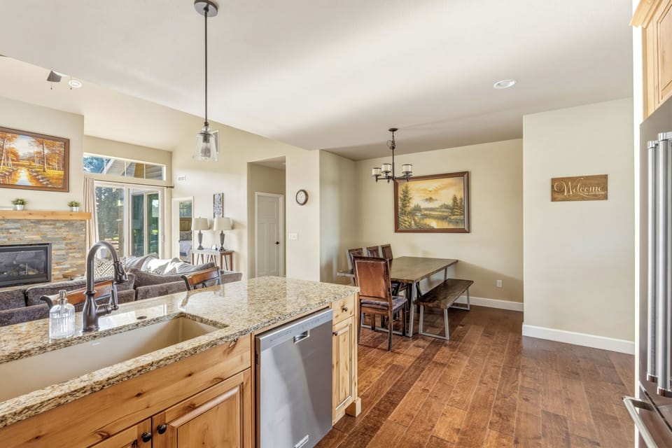 Granite peninsula with undermount sink and bar seating for three.