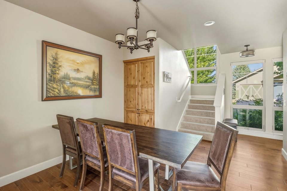 Dining table seats six or more — plus bar seating for three at the island.