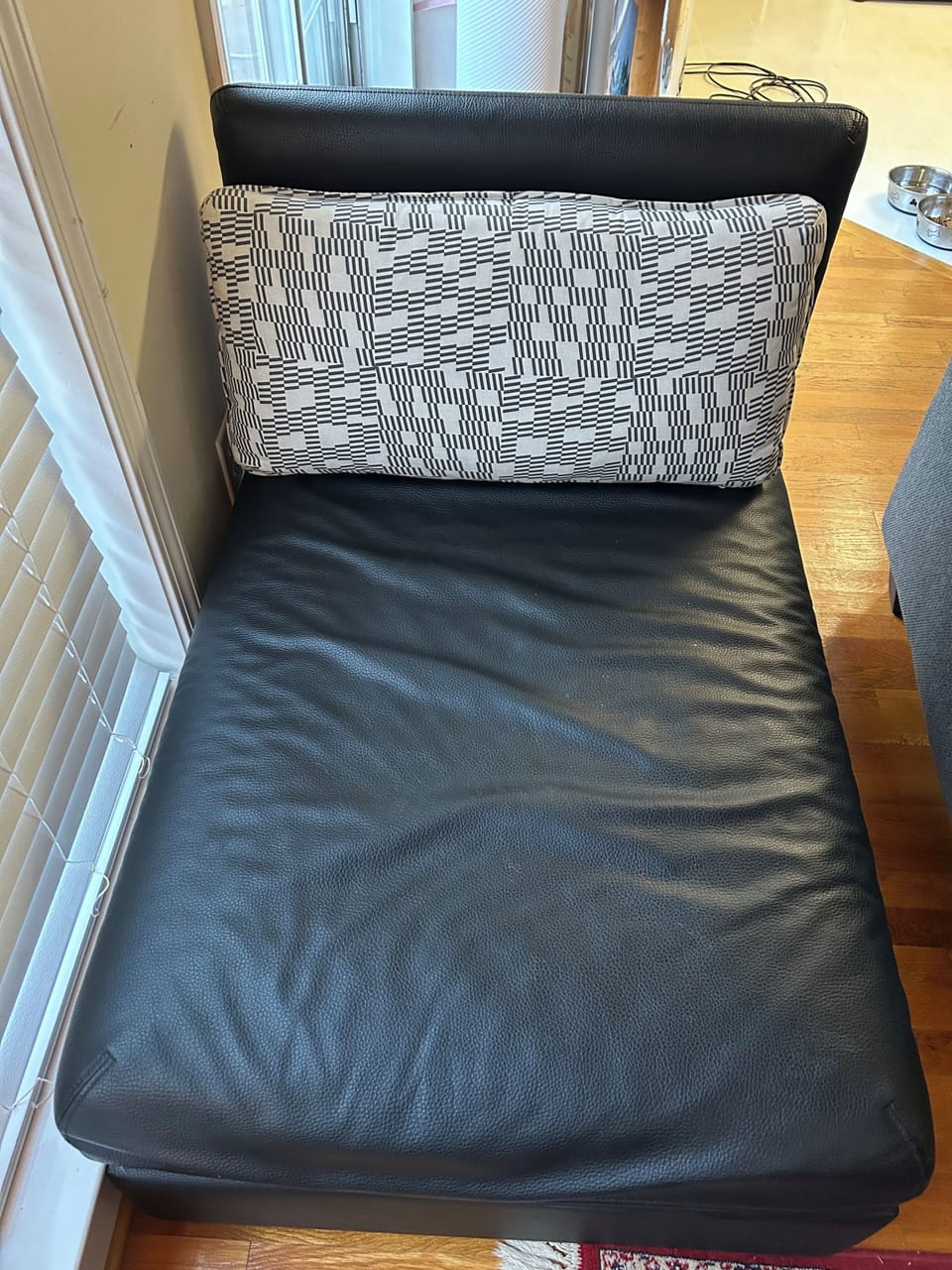 Black IKEA chair that pulls out into single bed