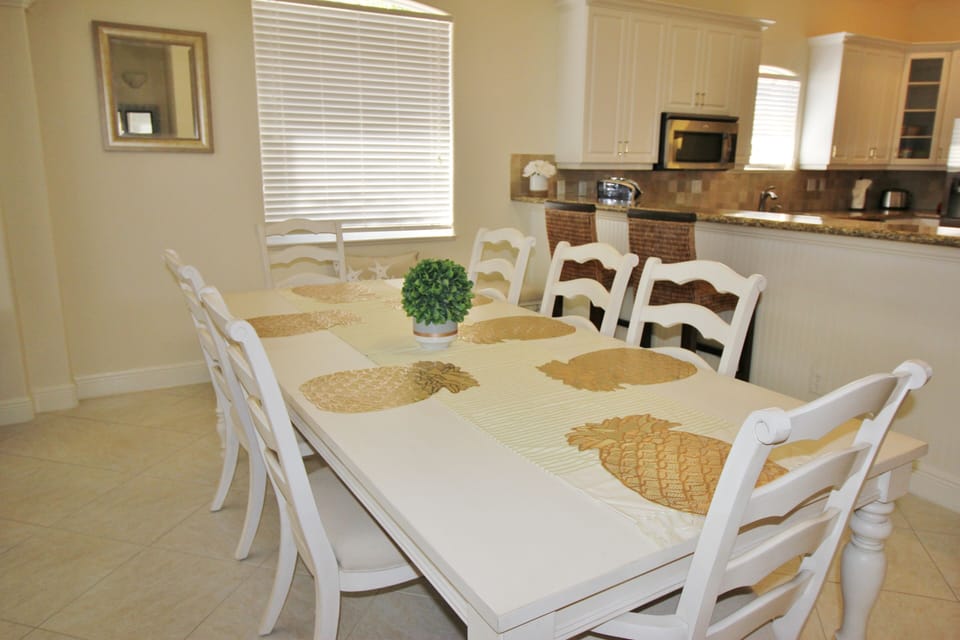 Dining area and open kitchen with bar stool seating.