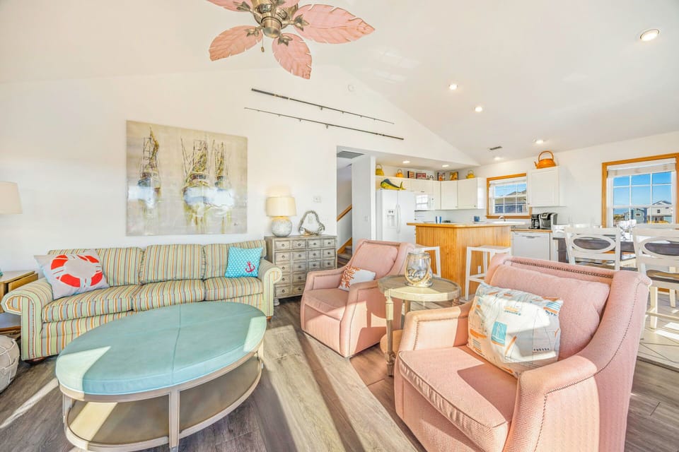Relax in your bright open-concept living space with comfortable seating, modern kitchen, and coastal charm throughout.