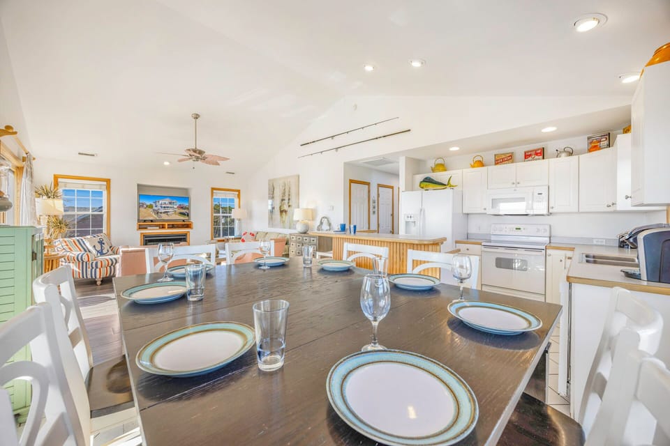 Gather around this elegant dining table where memorable meals await, seamlessly connected to your fully-equipped kitchen for effortless entertaining.