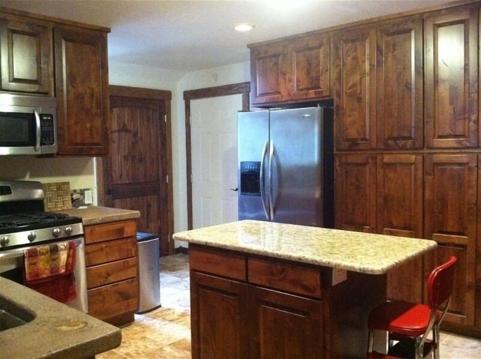 Fully oufitted gourmet kitchen with custom knotty alder cabinets.