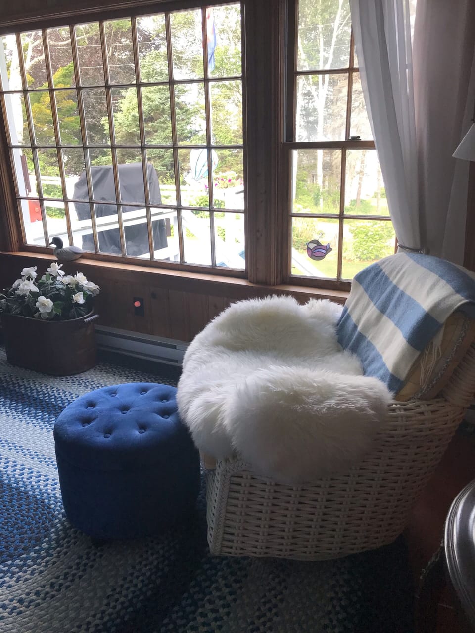 Comfortable swivel chair and ottoman, view ocean reading light behind chair