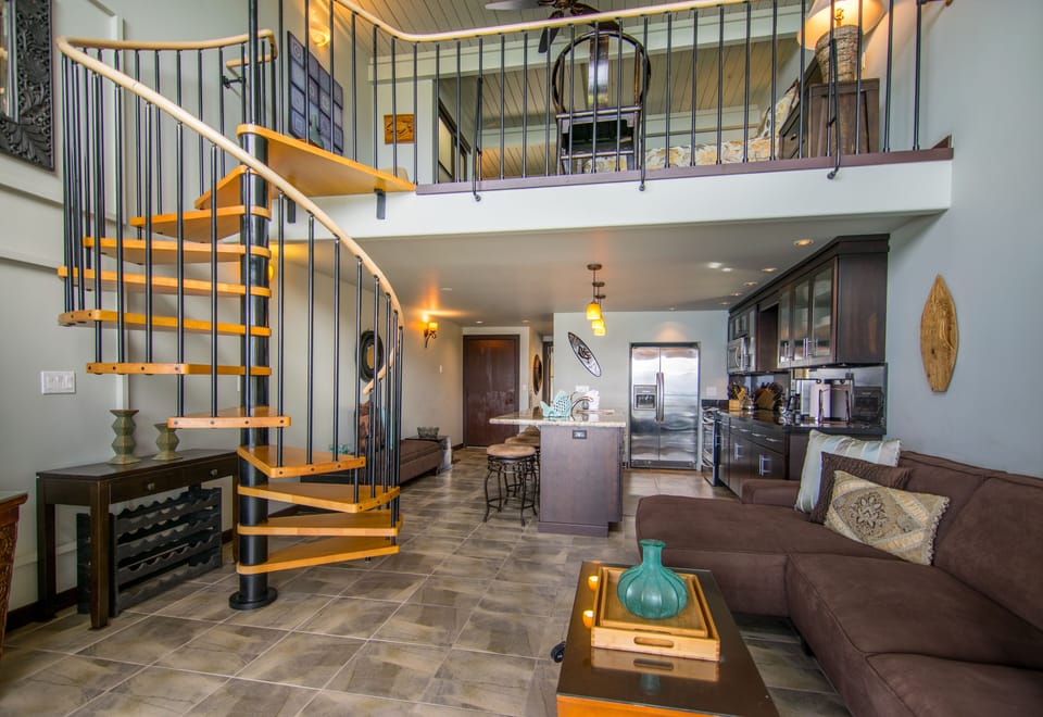 The open, spiral staircase ascends to the Master Suite.