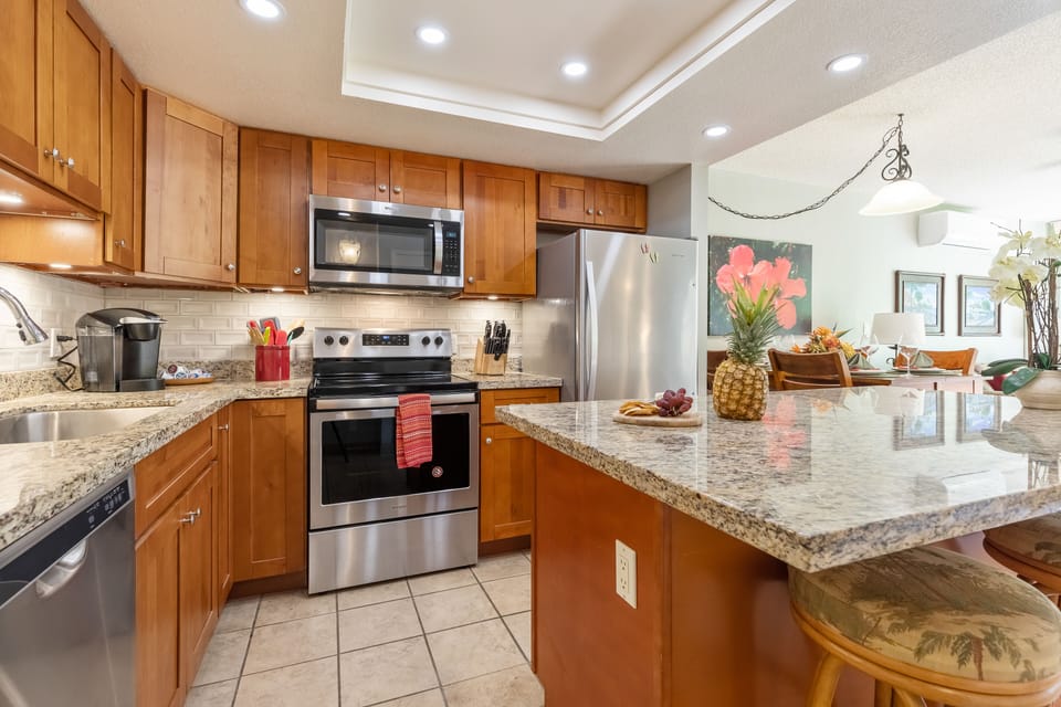 Fully equipped kitchen with granite counters and stainless steel appliance.