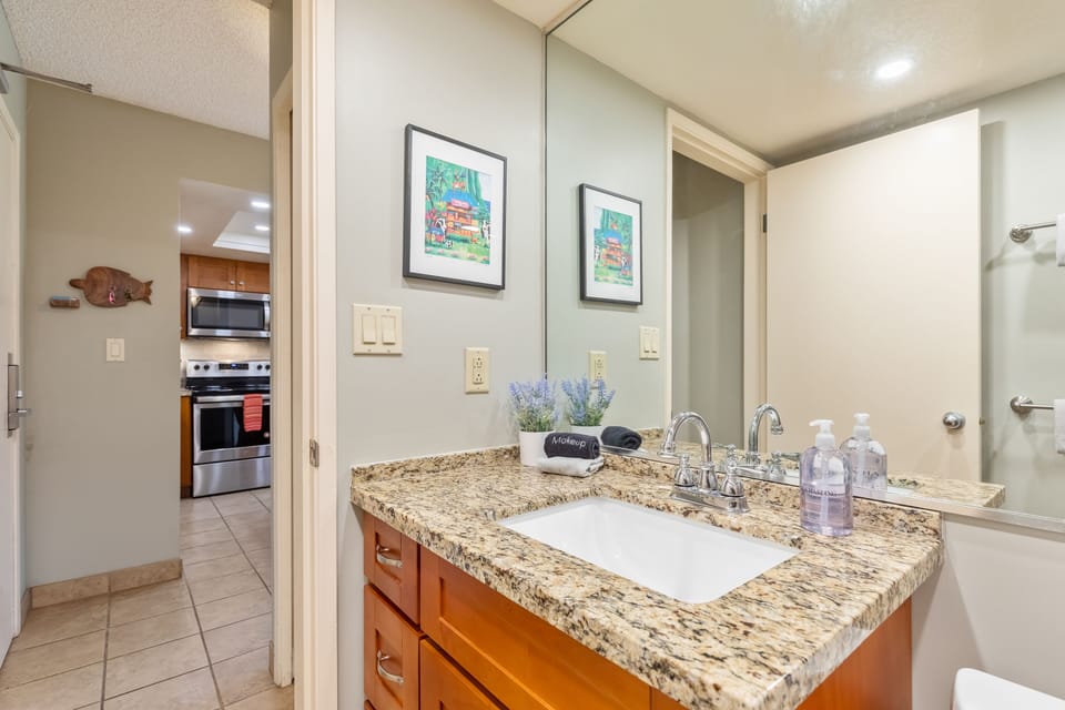 Bathroom off the kitchen, entry door is on the left.