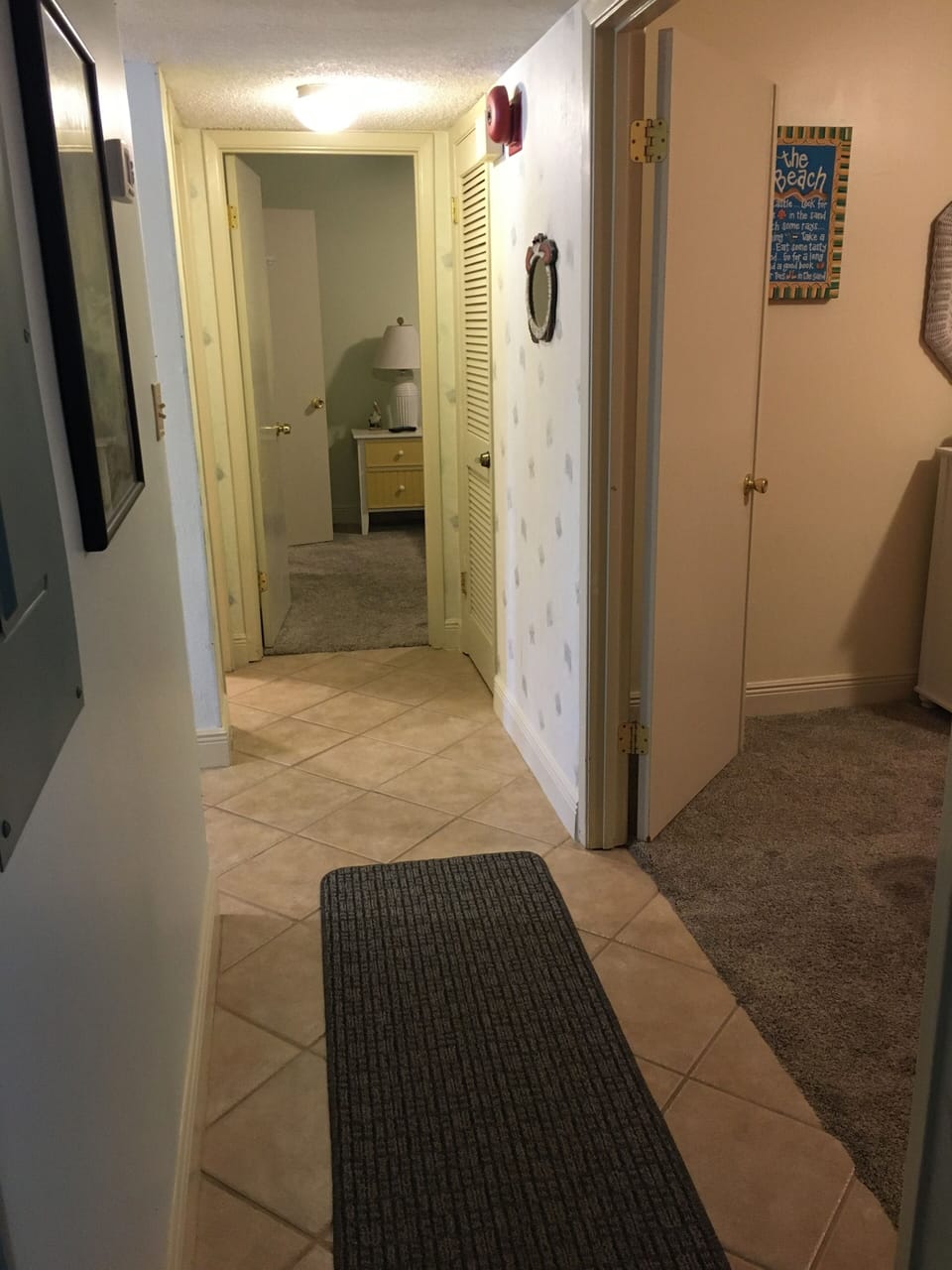 Hallway to twin bedroom on right, hall bath on left and King bedroom at end