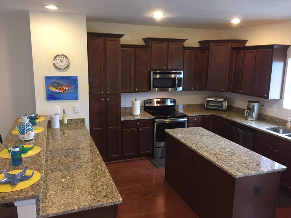 Large modern kitchen with stainless steel appliances and granite countertops
