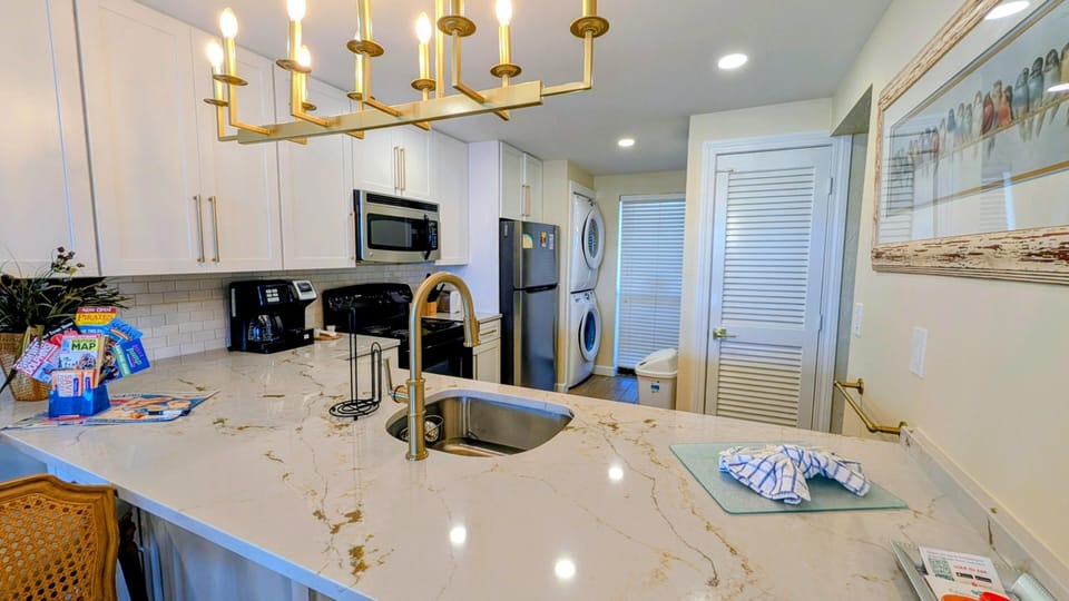 Modern kitchen with sleek countertops and ample lighting