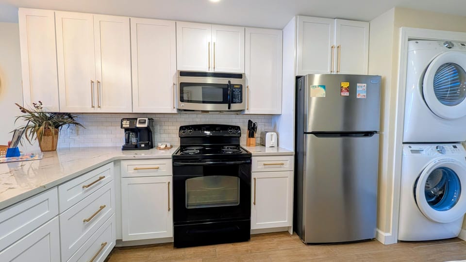 Modern kitchen with full appliances and convenient laundry area