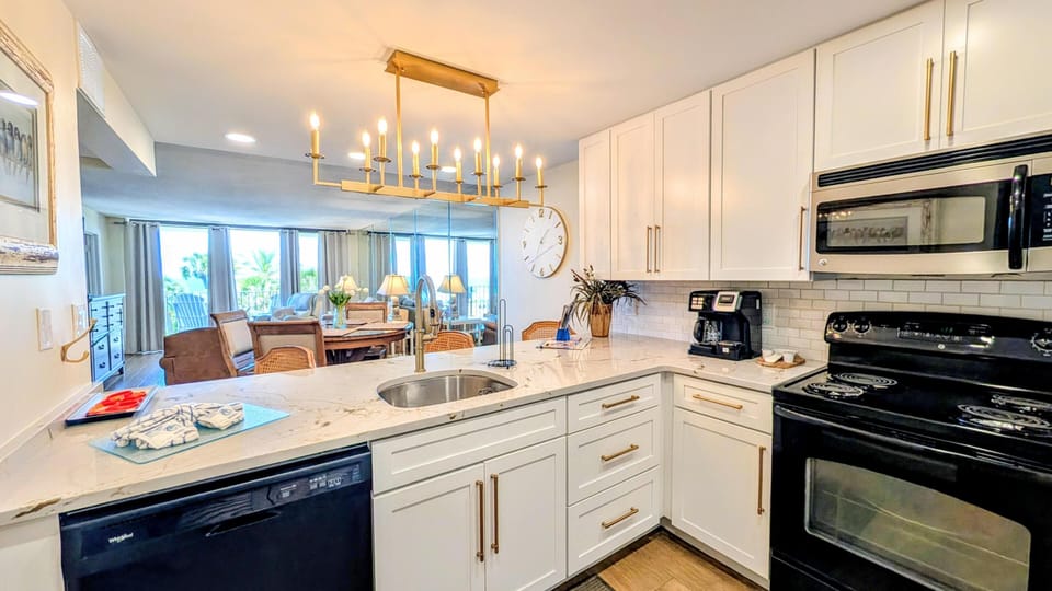Bright, modern kitchen flowing into spacious dining and living area