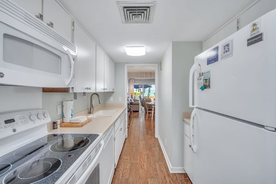 Kitchen features plenty of counter space and is fully stocked.