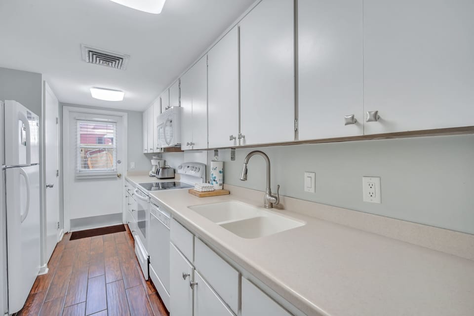 Kitchen features plenty of counter space and is fully stocked.
