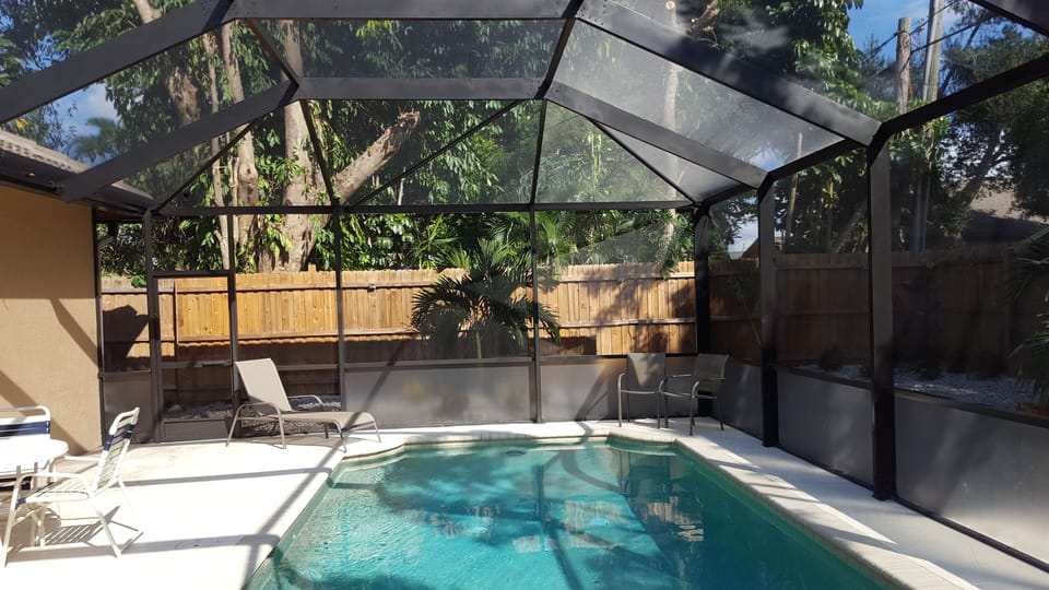 New fence, new cage, new landscaping with palms, new roof