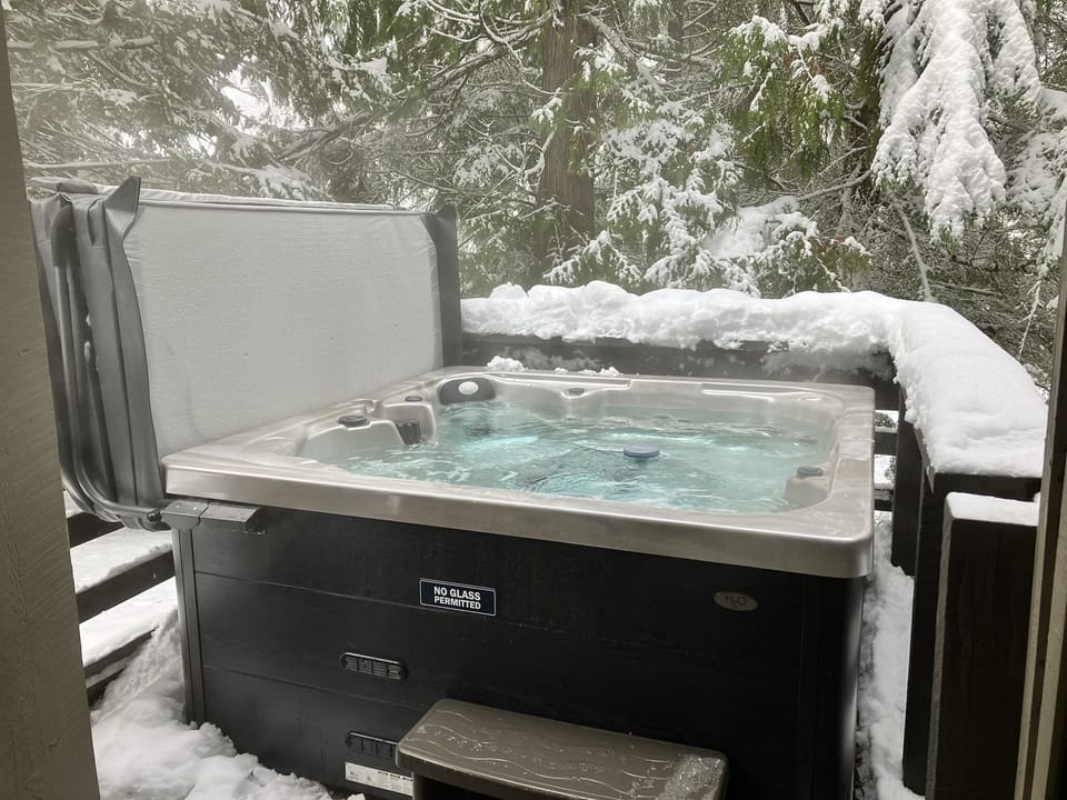 Relax in the large 6-seater private hot tub on the deck, among the trees.