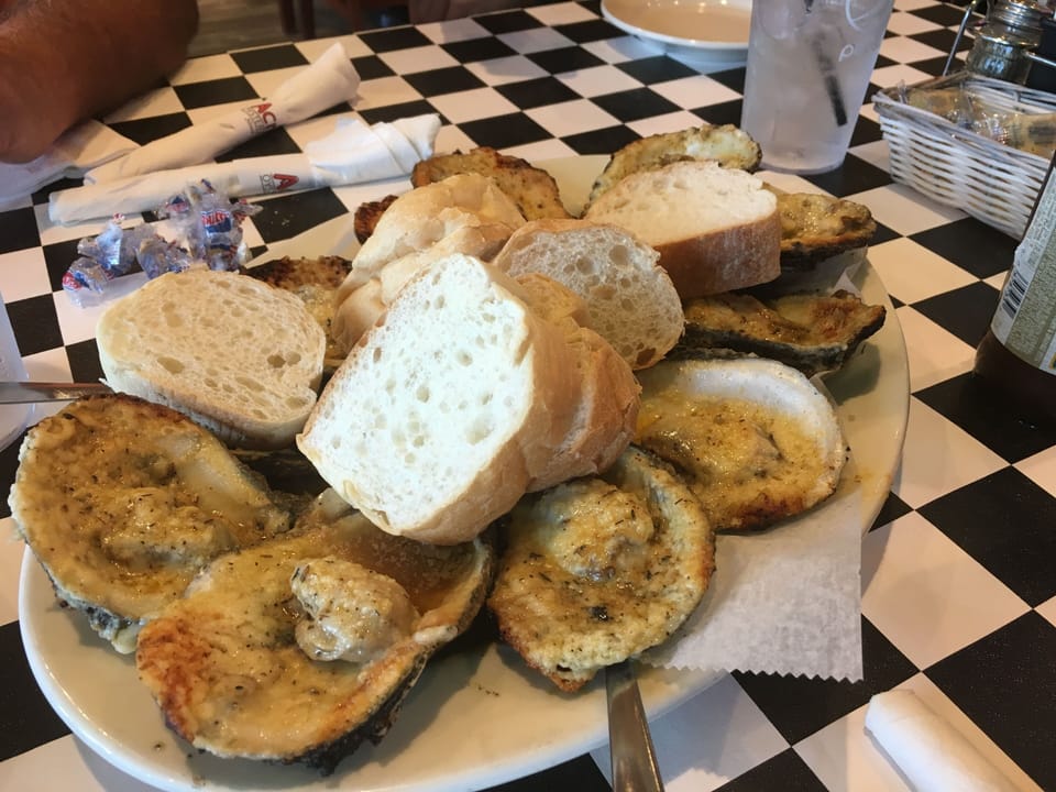 Grilled Oysters at Acme Oyster House one of our favorite spots